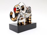 sculpture of an elephant on a black base with a red heart
