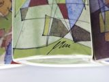 a close up of a plate with a painting on it