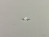 a close up of a single diamond on a white surface