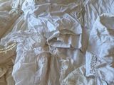 a bed that has a lot of white sheets on it