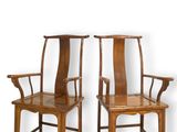 two wooden chairs with arms and arms are sitting next to each other