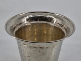 a silver cup that is sitting on a table