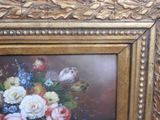 a picture of a painting of flowers in a gold frame