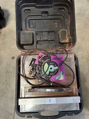 a tool box with some wires in it on the floor