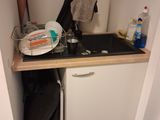 a small kitchen with a sink and dishwasher in it