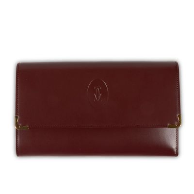 a brown leather wallet with a small logo on the front