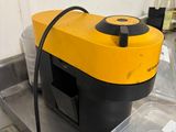 a yellow and black machine sitting on top of a table