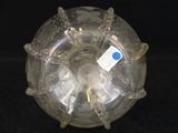a clear glass object with a blue label on it