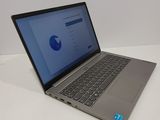 the laptop is open on a white surface with a blue screen