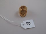 a small gold ring with a price tag attached to it