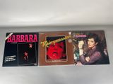 a couple of records sitting on top of a table