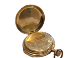 a gold colored pocket watch with a chain around it