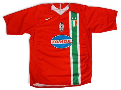 a close up of a red soccer jersey with a green and white stripe