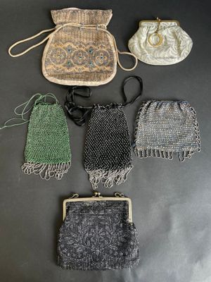 a group of purses sitting on top of a table next to each other