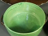 two green bowls sitting on a table next to each other