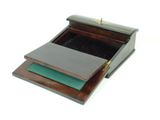 a small wooden box with a green pad on top of it