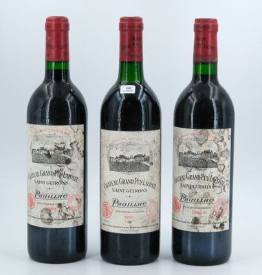 three bottles of wine are lined up on a white surface