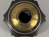 a close up of a metal object on a white surface