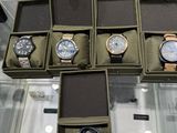 several watches are displayed in a display case on a glass table