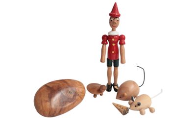 a wooden toy that is standing next to other toys