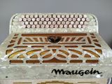 a close up of a white accordion on a table