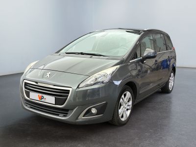 the small grey car is parked in a room with a black floor