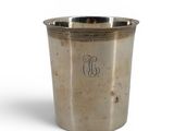 an old silver cup with a monogram on the side