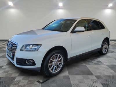the white audi suv is parked on a checkered tile floor