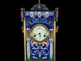 an image of a blue and gold clock sitting on top of a table