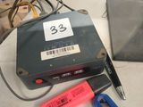a hard drive and a pair of pliers on a table