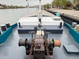 a boat with a chain on the front of it on the water