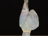 an image of a glass sculpture of a rooster on a table