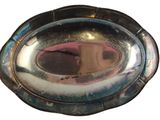 a silver plate with a mirror in it on a white surface
