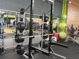 a picture of a gym room with a weight rack and weights