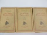 three books are sitting on top of a white table