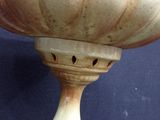 a white bowl with holes in it sitting on a table