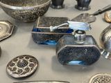 a table with a lot of silver objects on it