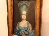 painting of a young girl in a blue dress with a blue headdress