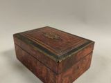 an old wooden box sitting on top of a white surface