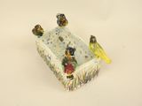 three birds sitting on top of a box with a bird on it