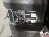 a close up of a black and white sign on a machine