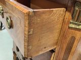a wooden dresser with a drawer on top of it