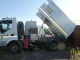 a white dump truck that is parked in a lot