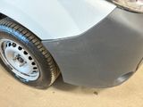 a close up of a car ' s front bumper and tire