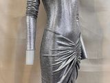 a mannequin mannequin dress with long sleeves and a draped skirt