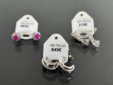 three tags are shown on a table with a pair of rings