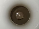a close up of a toilet bowl with a toilet paper dispenser in it