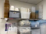 many plastic containers on the shelves in the room