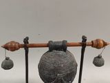 an image of a metal object with bells on it