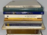 several books are stacked on top of each other on a table